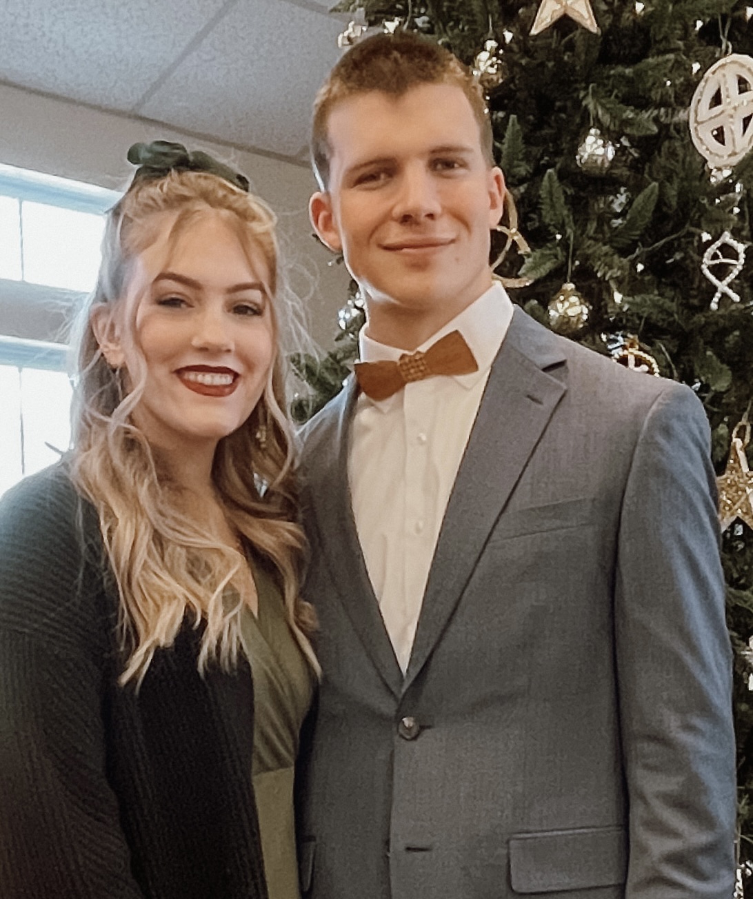 Jacob Kern in a blue suit standing next to his wife.